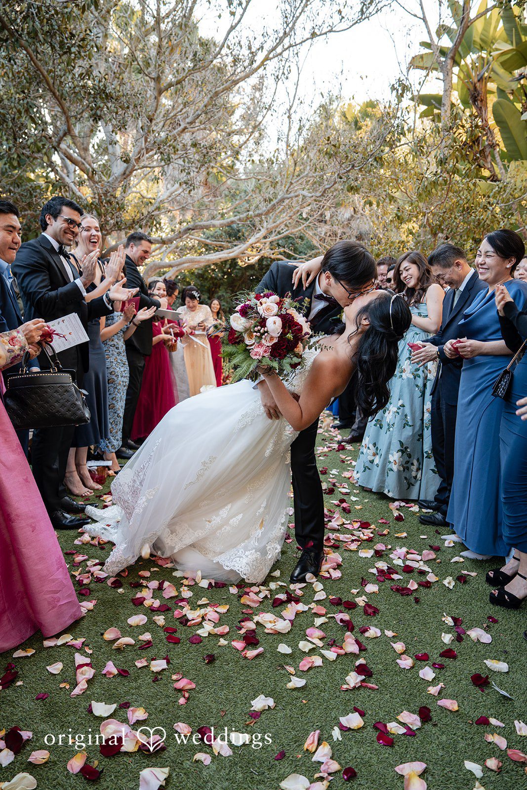 The couple shares a romantic kiss on the aisle
