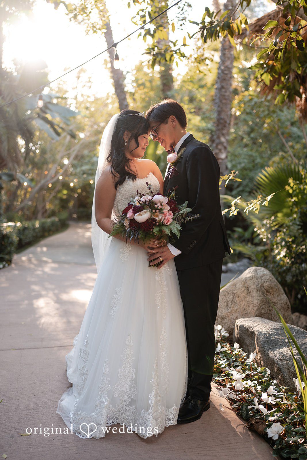 A romantic portrait of the couple by the garden way