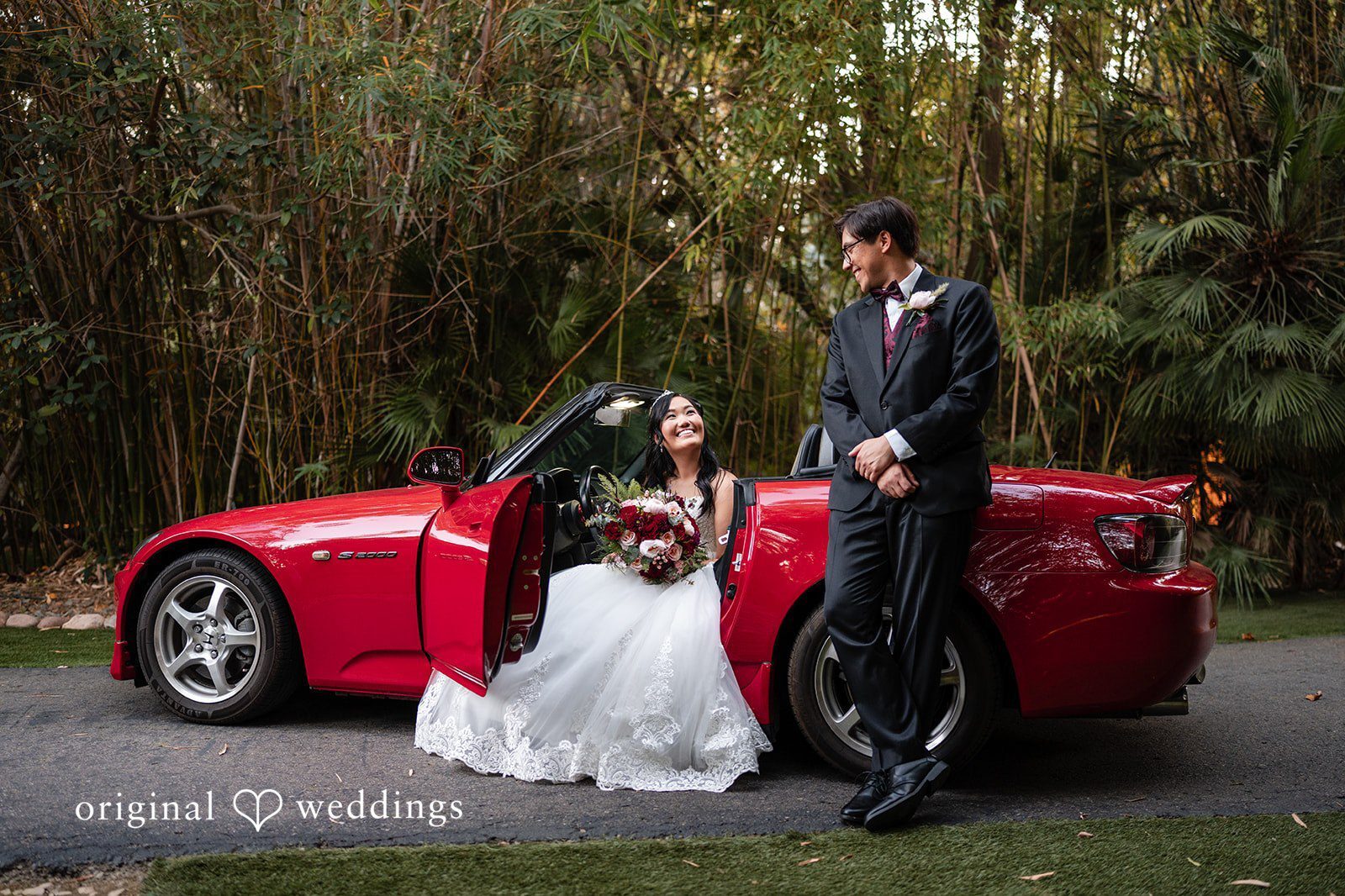 Our San Diego Wedding Photographers at Original Weddings captured a stunning portrait of the couple by their red car at Botanica