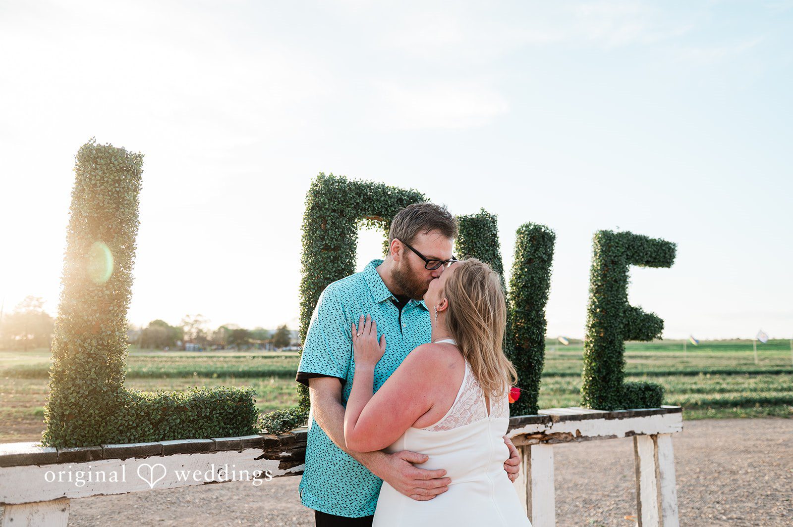 Suzanna + Morgan Romantic couple moment with windmill backdrop and flower fields