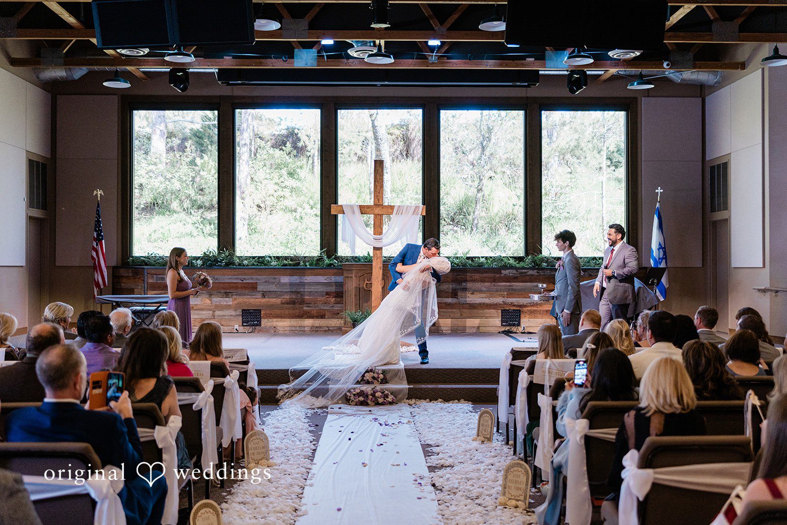 Couple sharing first kiss after wedding ceremony at Calvary Chapel Bible Fellowship