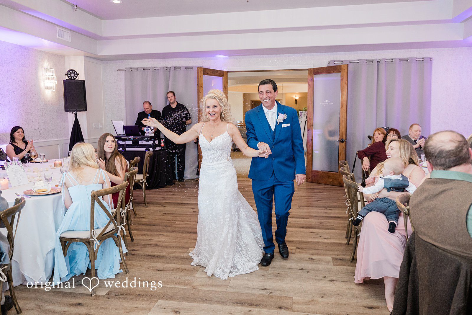 Bride and groom making their grand entrance into the reception venue.