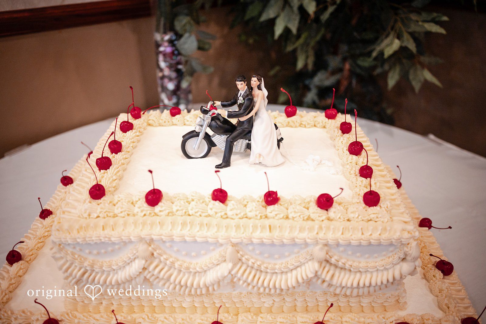 Elizabeth + Aldo Wedding cake detail with floral accents and bride and groom topper