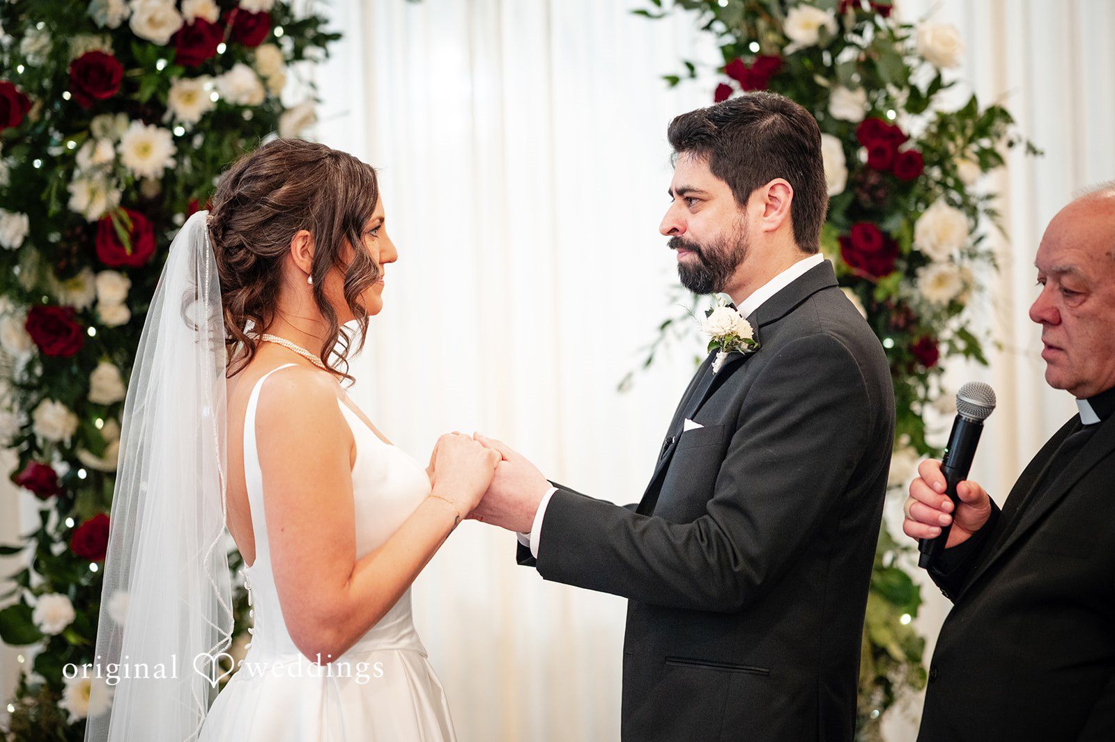 Elizabeth + Aldo Bride and groom holding hands during the wedding ceremony