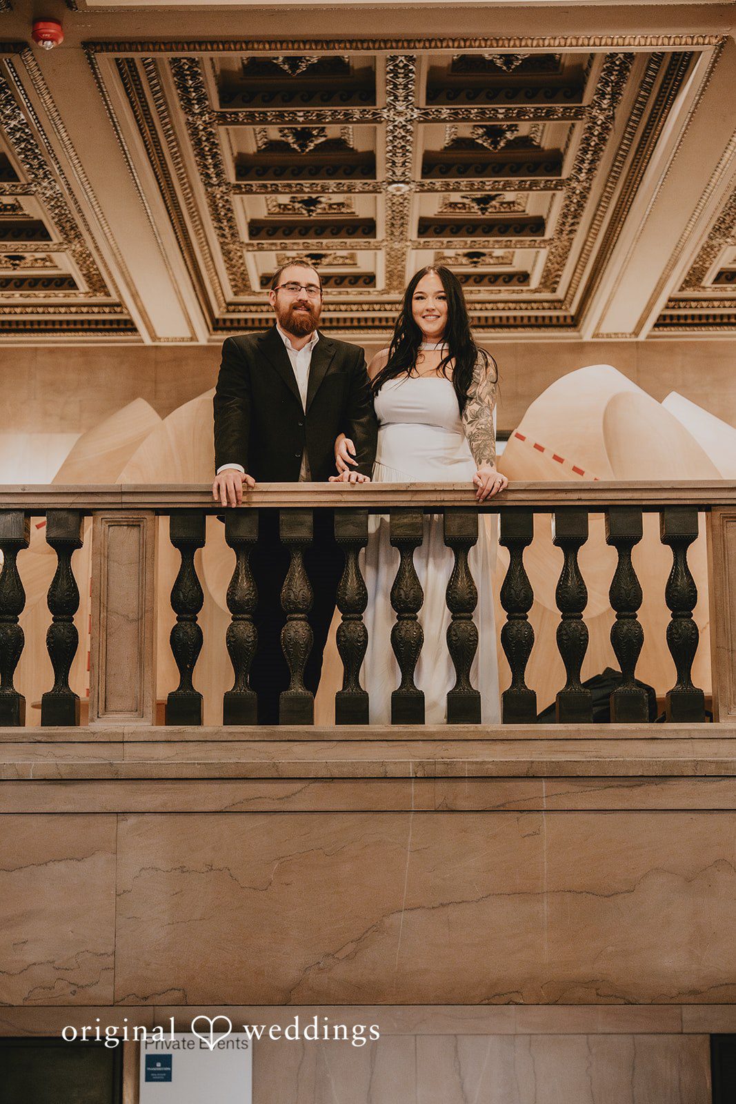 A gorgeous portrait of the couple by the gallery