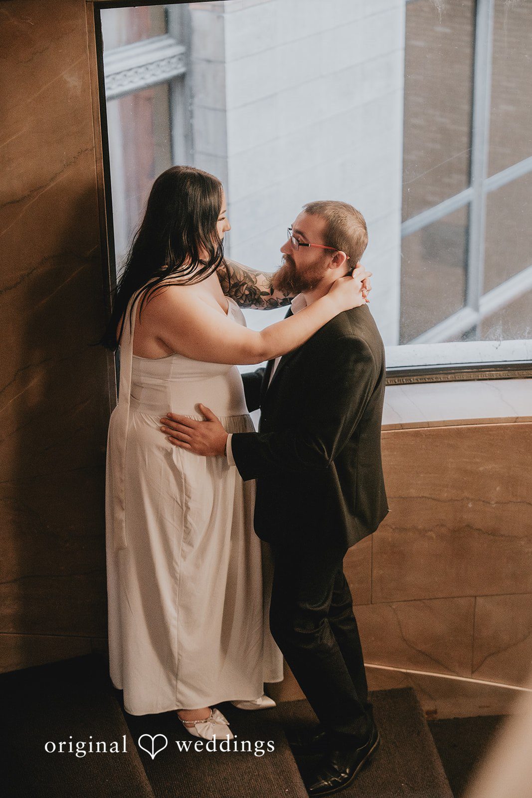 A romantic portrait of the couple by the stairs