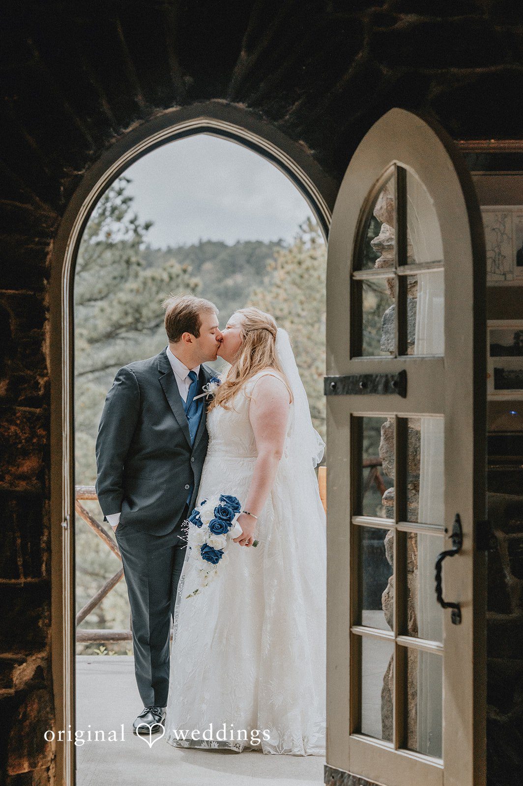 Kelsi + Christian The couple shares a kiss by the door