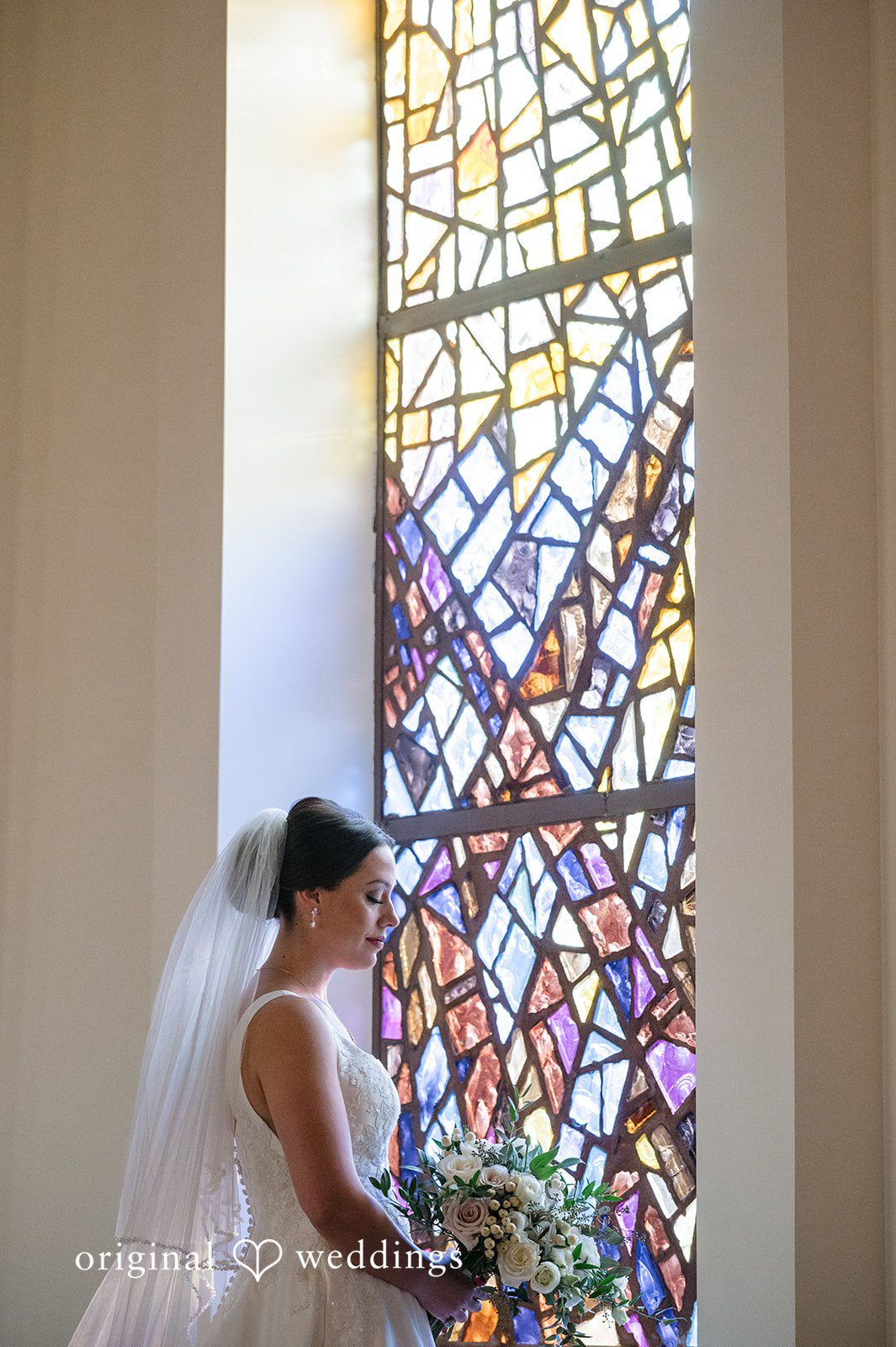 Romantic bridal portrait beside stained glass windows at Christ Covenant Sandy Springs