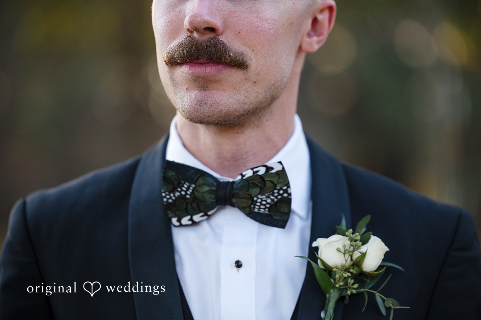 Close up groom portrait showcasing classic wedding attire and boutonniere styling