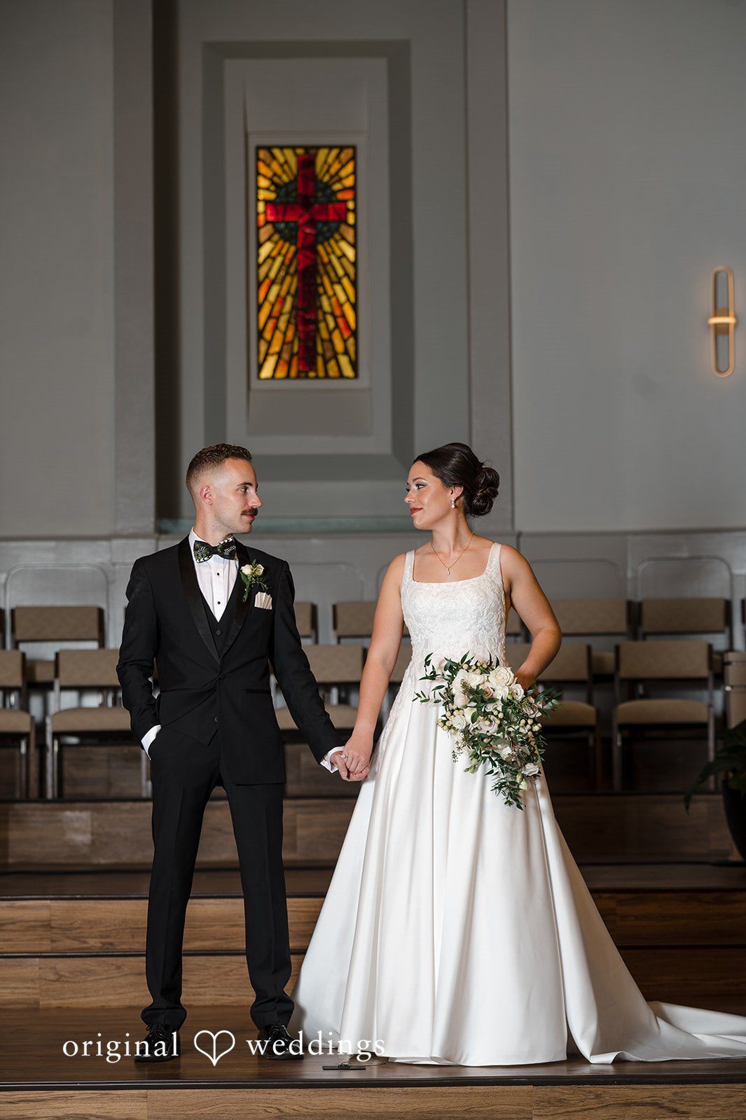 Bride and groom holding hands inside Christ Covenant Sandy Springs