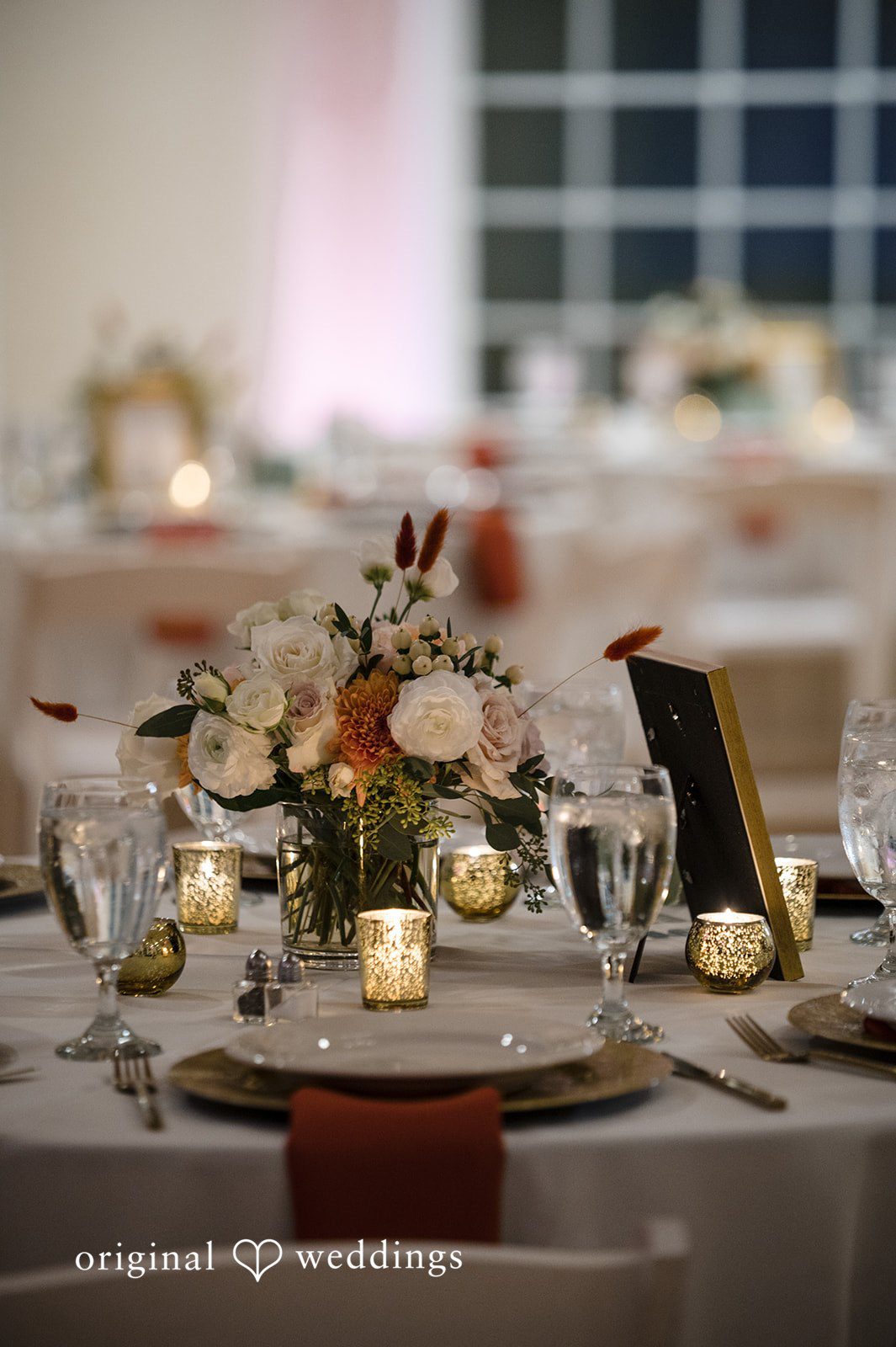 Elegant wedding reception table decor with candles and floral centerpiece at Christ Covenant Sandy Springs