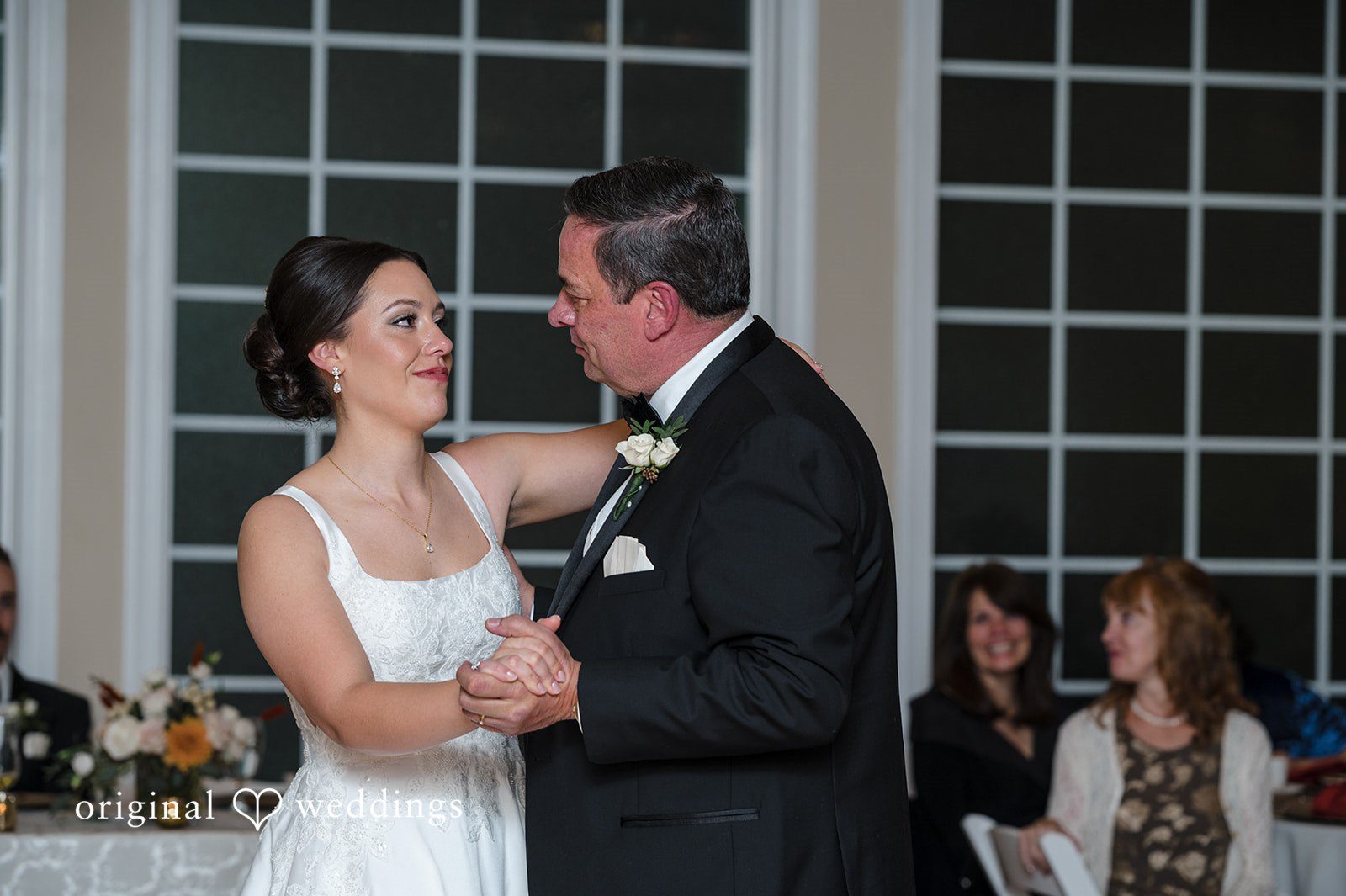 Bride sharing an emotional dance during wedding reception celebration