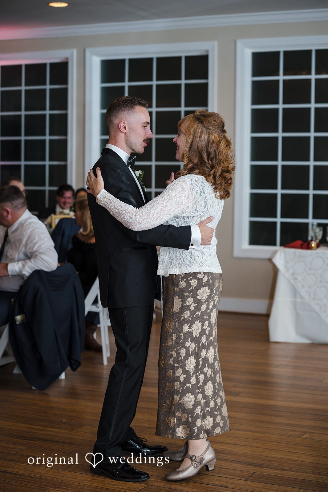 Groom sharing a meaningful family moment on the wedding dance floor