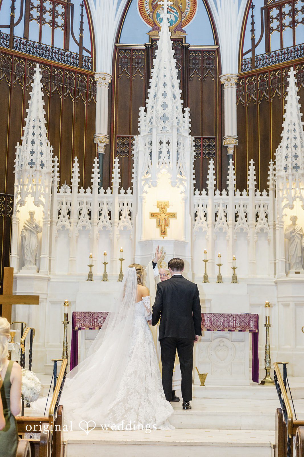 The priest blesses the couple’s union