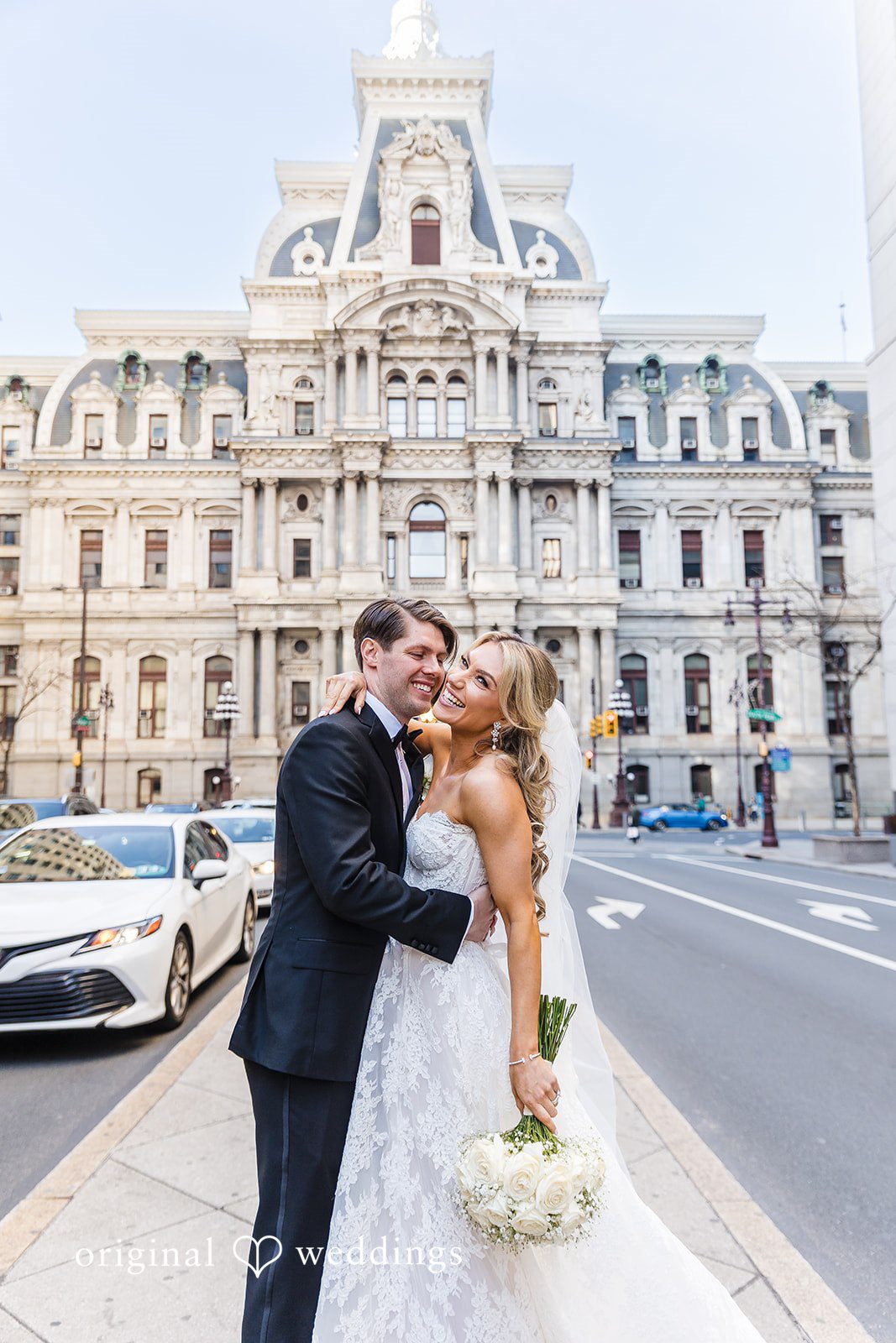 A joyful portrait of the couple in the church grounds