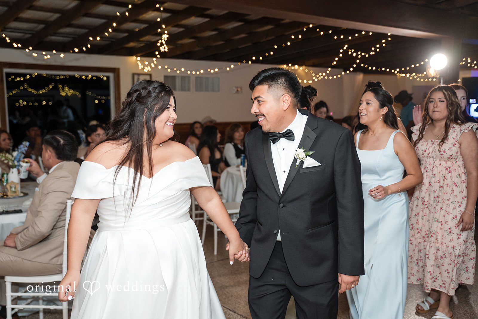 Cecilia + Jose Houston Wedding Photographers capturing bride and groom holding hands and smiling at each other at Circle of Seven Ranch by Original Weddings
