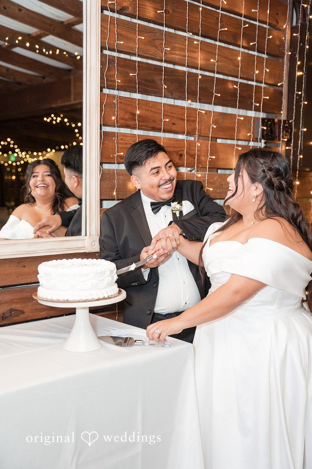 Cecilia + Jose Romantic couple cake cutting moment during wedding reception