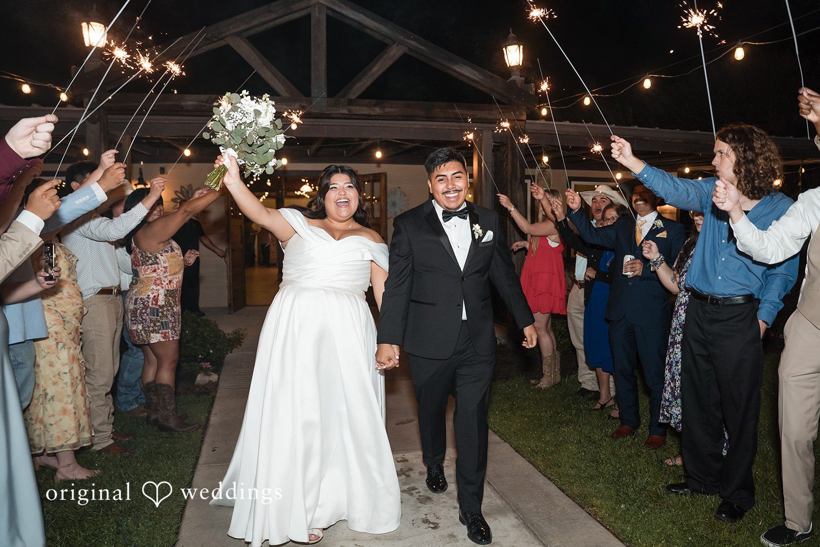 Cecilia + Jose Houston Wedding Photographers capturing bride and groom holding hands while walking outside at Circle of Seven Ranch by Original Weddings