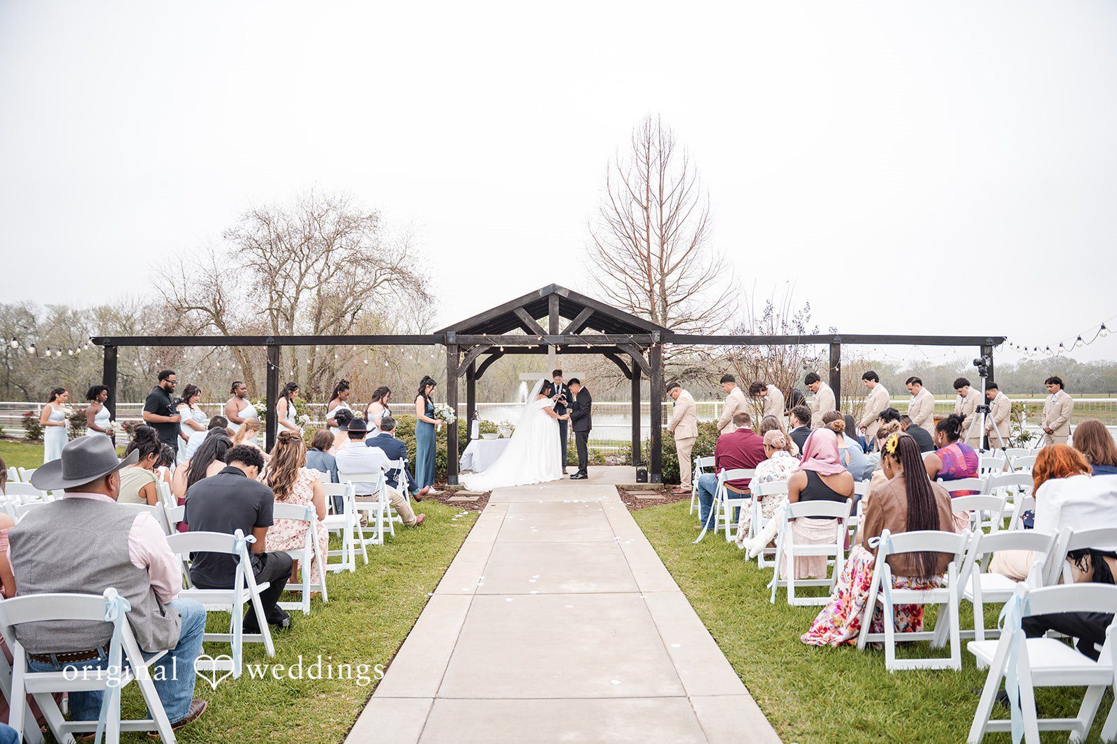 Cecilia + Jose Elegant ceremony scene with couple listening to priest