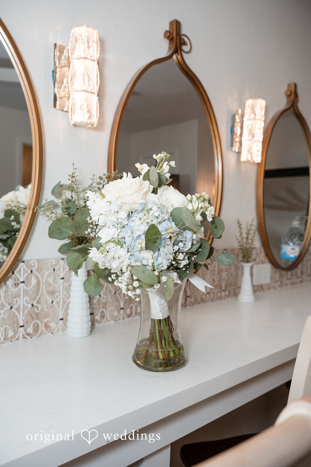 Cecilia + Jose Vase with flowers displayed near mirror