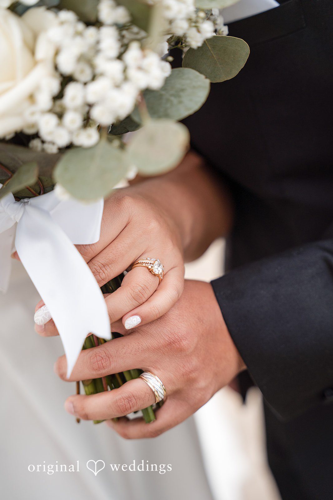 Cecilia + Jose Close-up of bride and groom hands with wedding rings at Circle of Seven Ranch