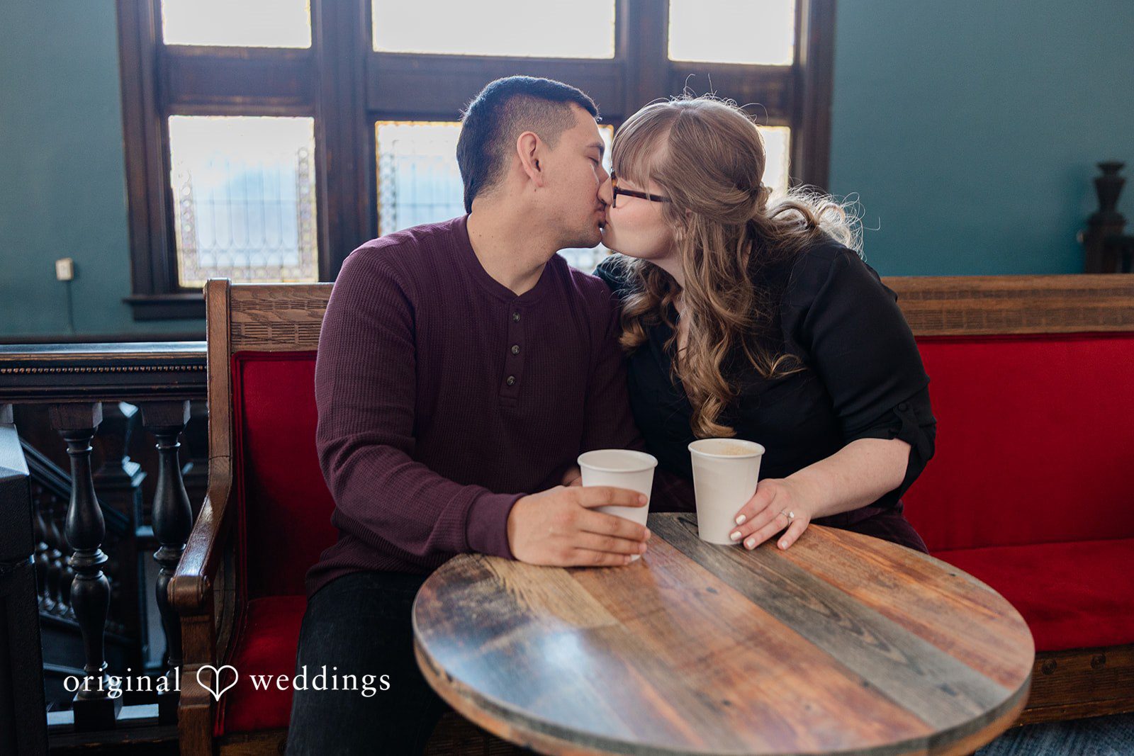 Romantic kiss moment of couple at Coat Check Coffee
