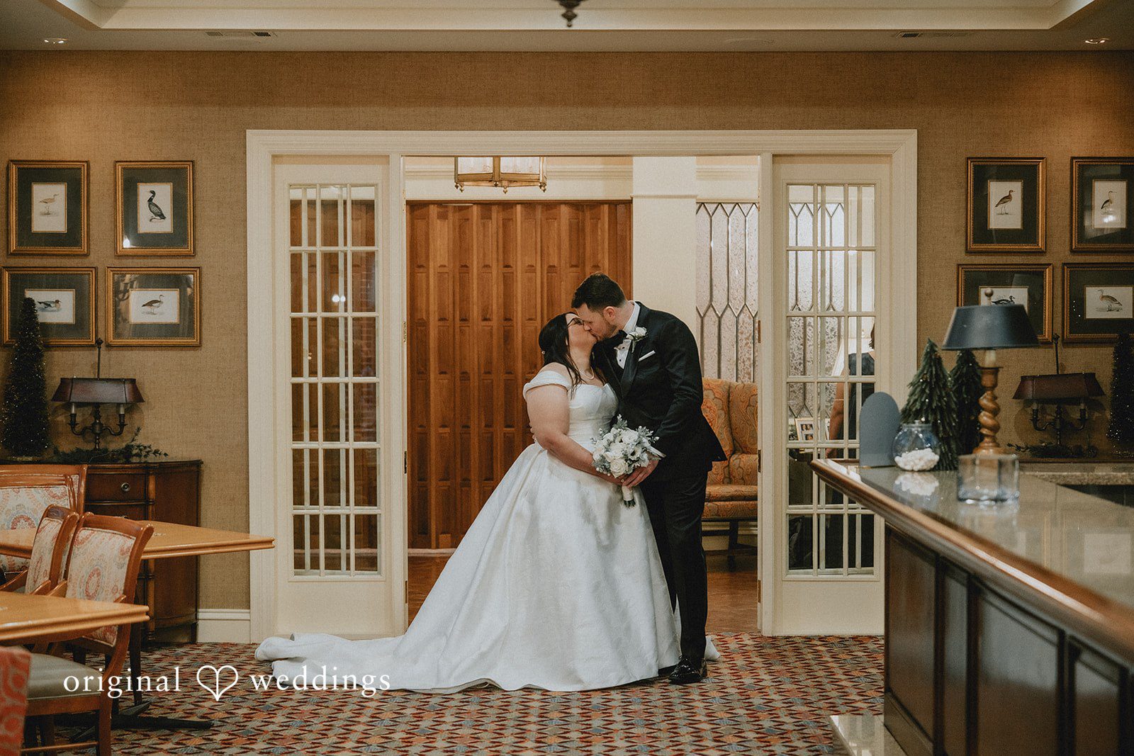 Bride and groom sharing a kiss during romantic portraits