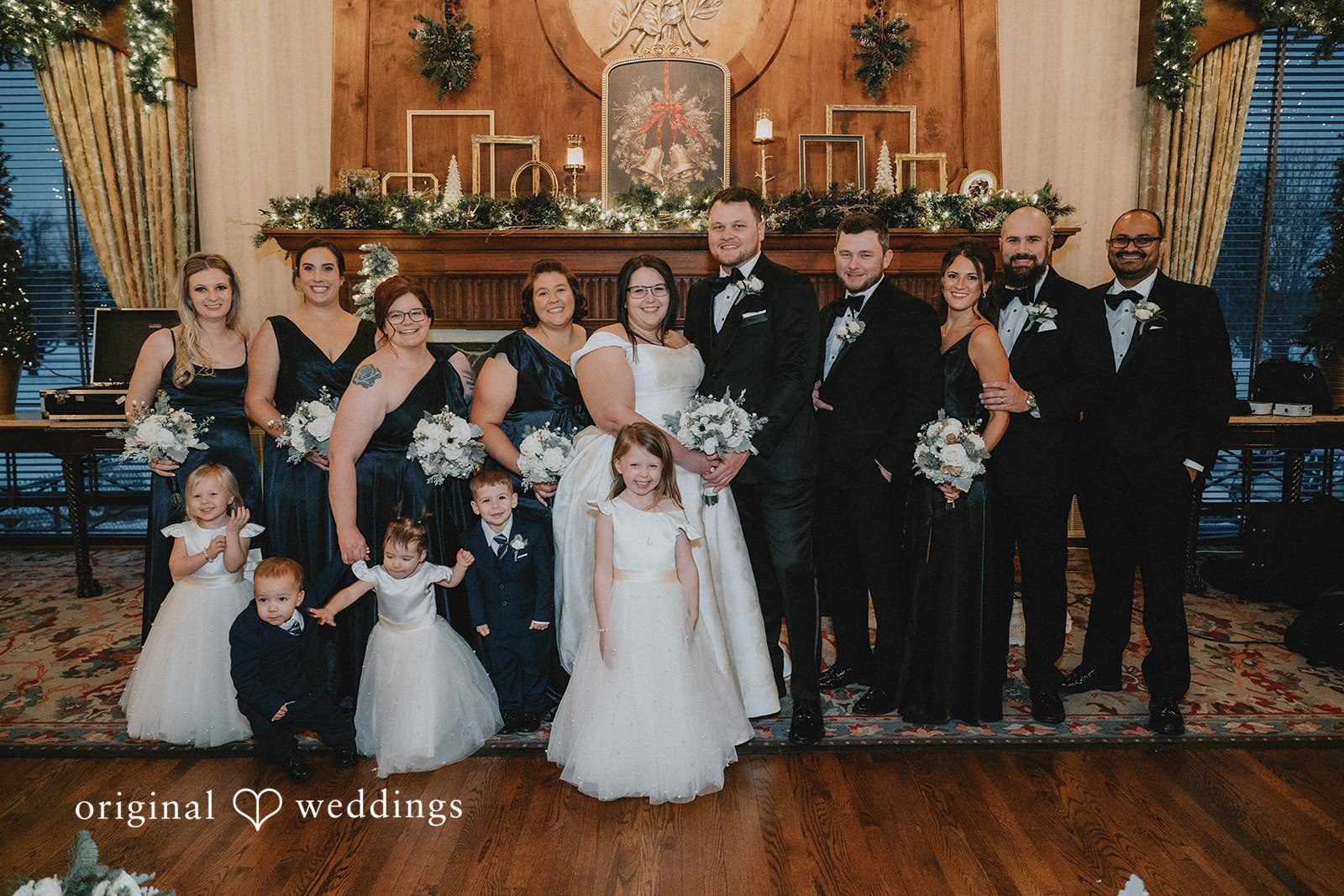 Bride and groom posing with the full wedding party