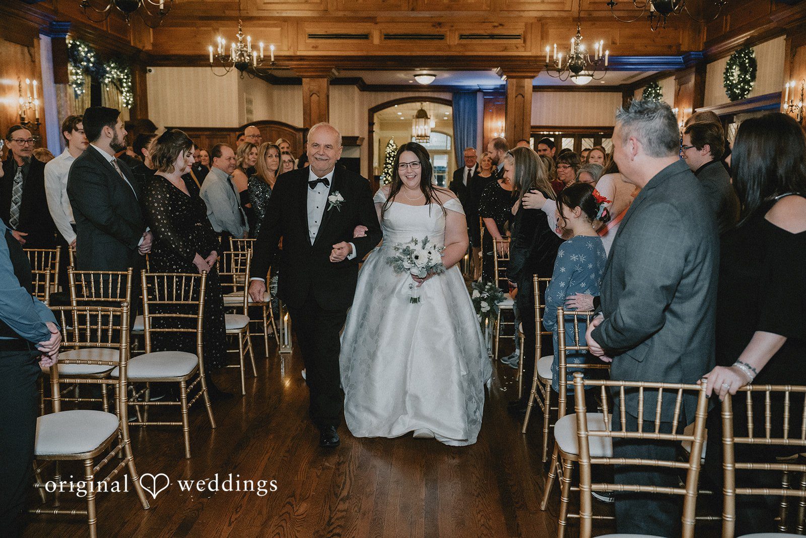 Bride walking toward the ceremony with her father