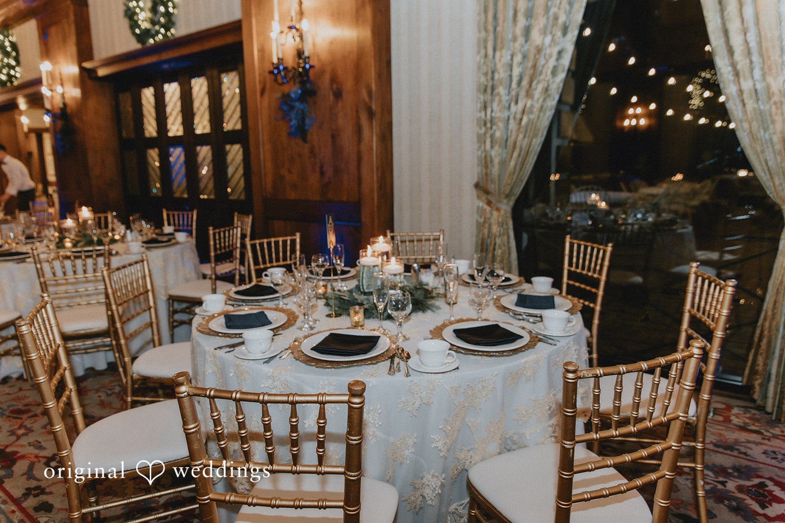 Close-up of reception table decor with candles and florals