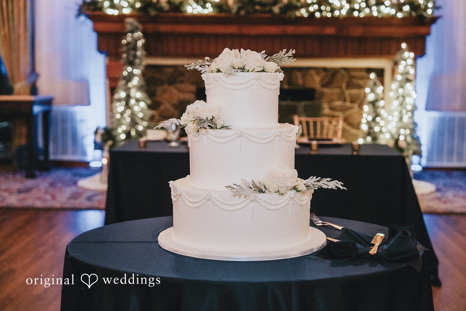 Elegant three-tier wedding cake with classic floral details