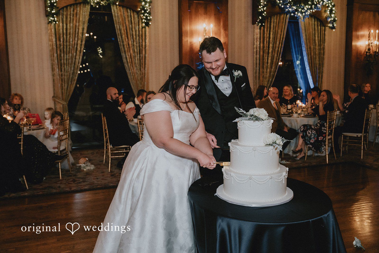 Bride and groom cutting their wedding cake together