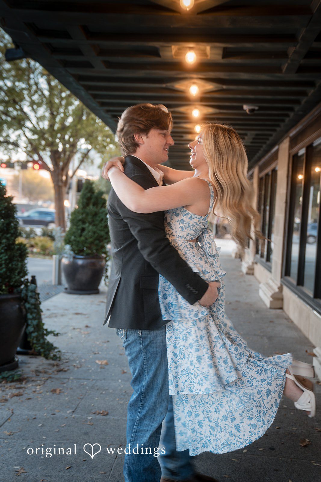 A man lifting a woman at Colcord Hotel during photo session