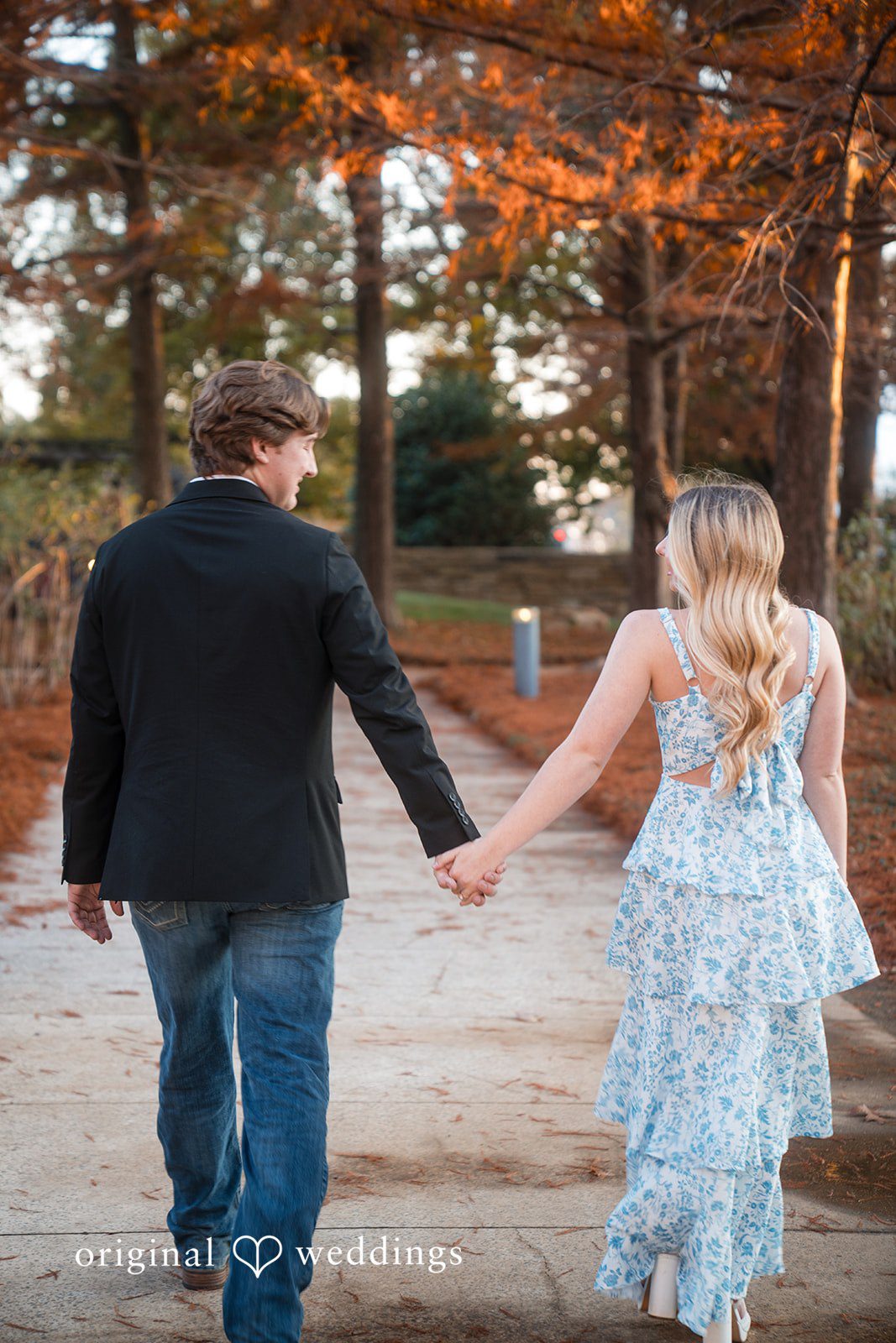 Couple walking through the garden hands in hands