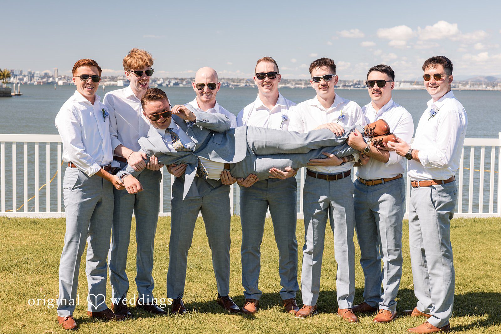 Groom and groomsmen sharing joyful wedding moment at Colorado Cays Yacht Club