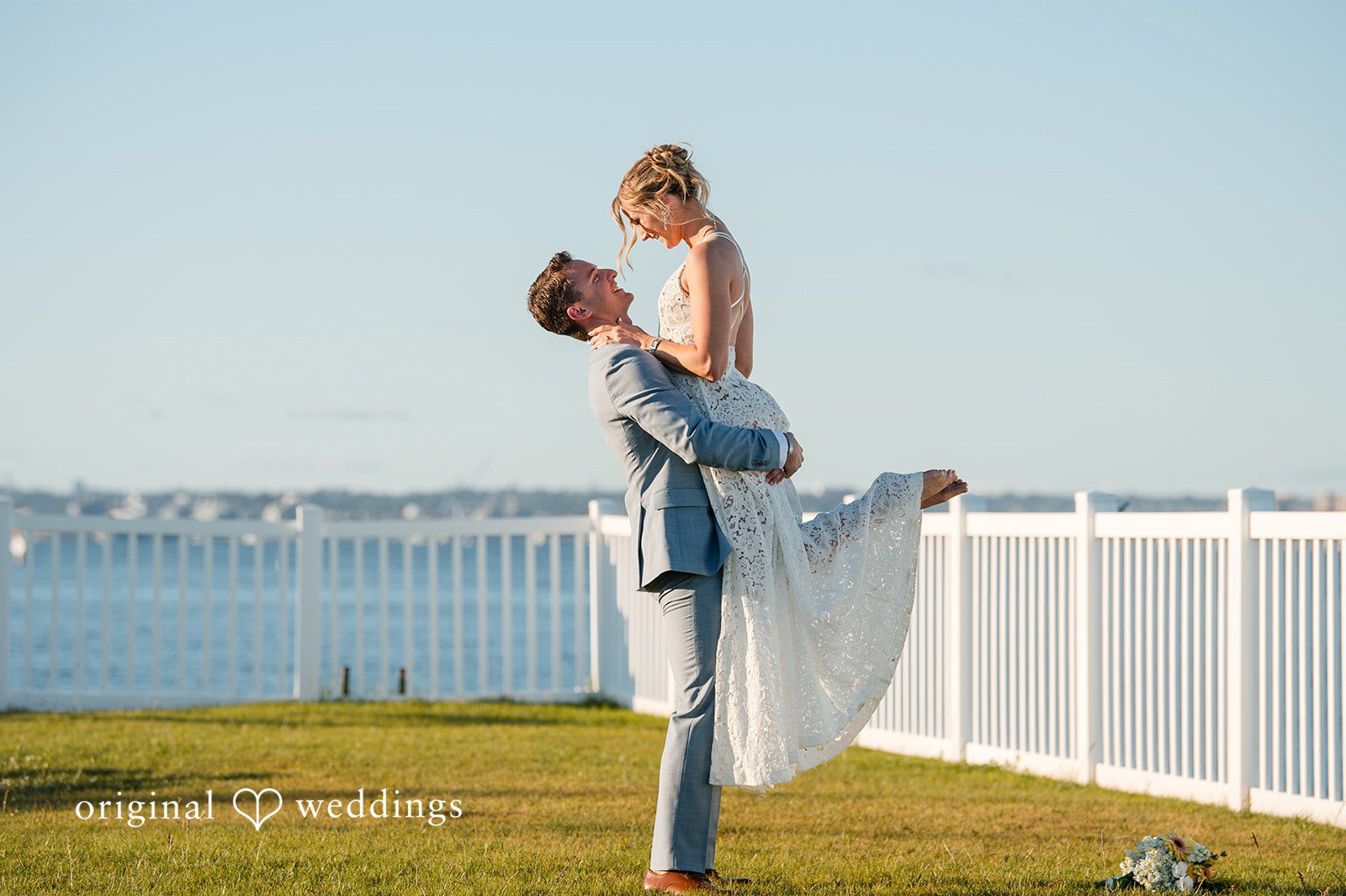 Romantic groom carrying bride portrait at Colorado Cays Yacht Club captured by San Diego Wedding photographers from Original Weddings