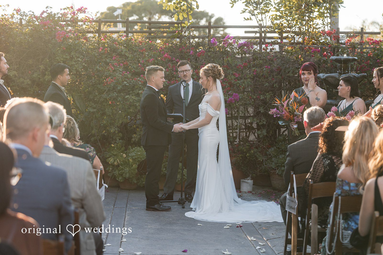 Bride and groom exchanging vows during a ceremony at Cuvier Club by Wedgewood Weddings.