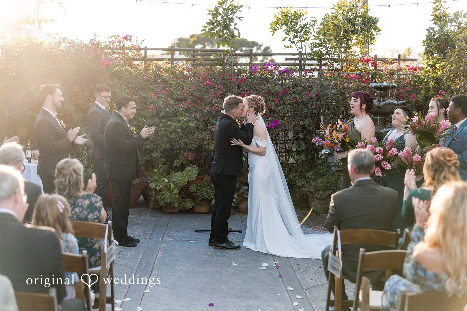 Bride and groom kissing at the altar.