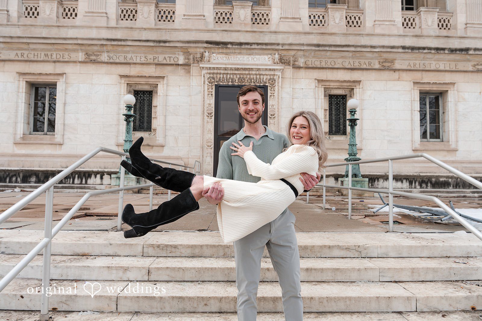 Groom holding up the bride joyfully at Detroit Public Library