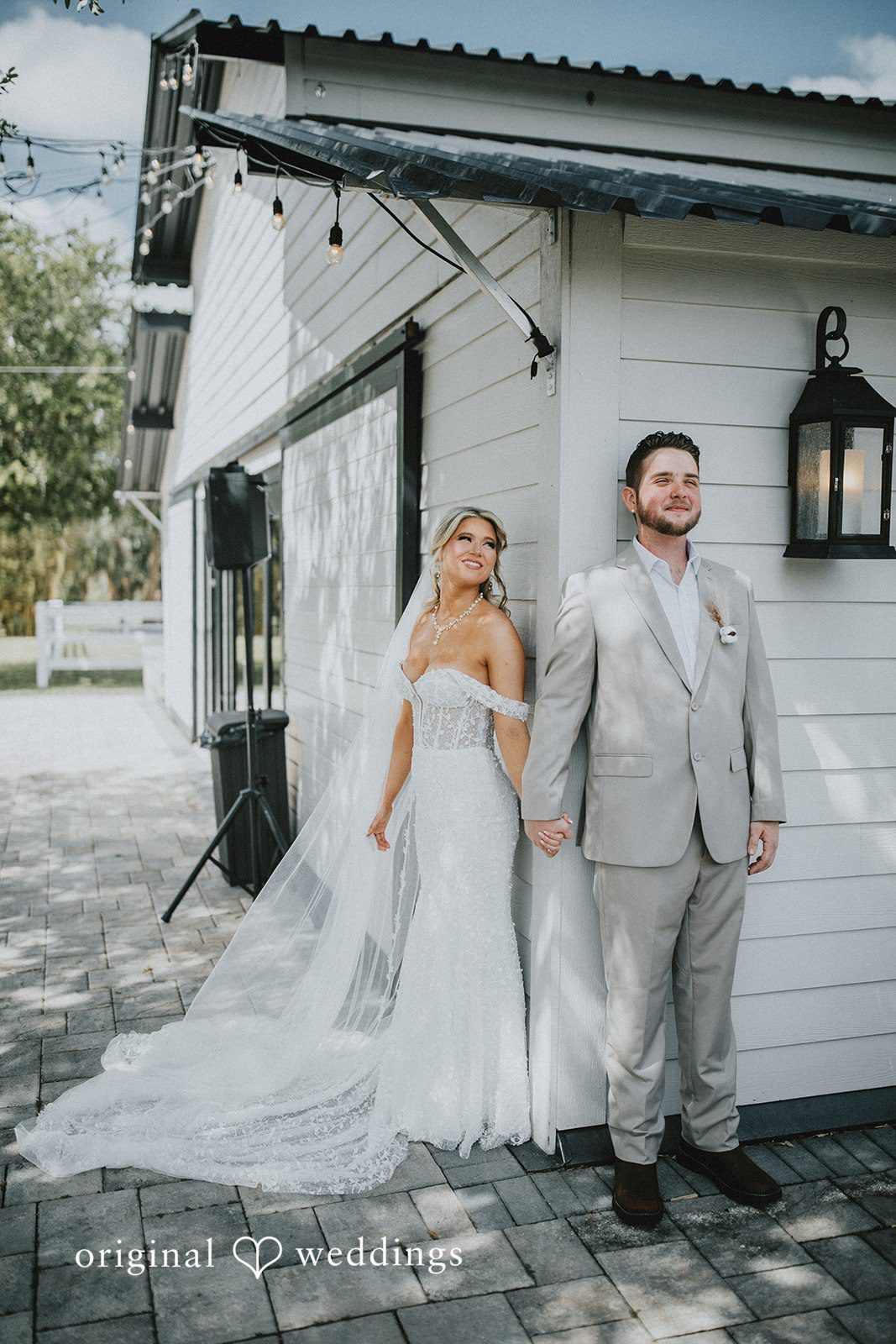 Catalyna + Nik Bride and groom holding hands outside the venue