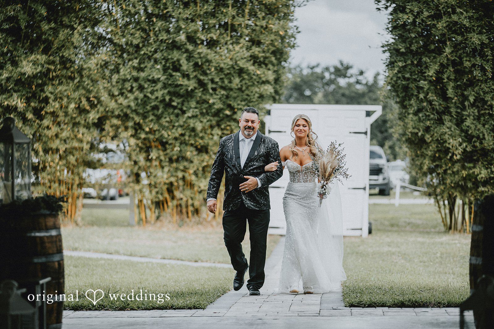 Catalyna + Nik Bride walking down the aisle outdoors