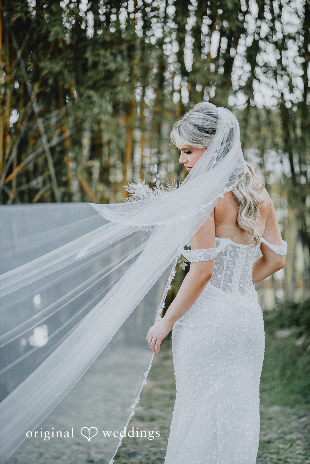 Catalyna + Nik Bride posing with flowing veil outdoors