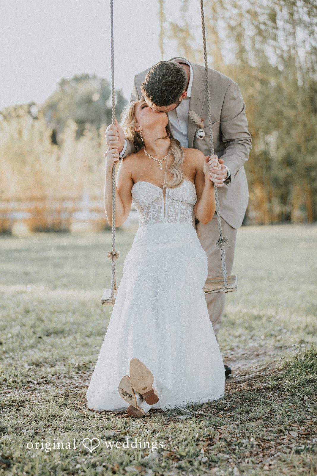 Catalyna + Nik Bride and groom kissing on a wooden swing
