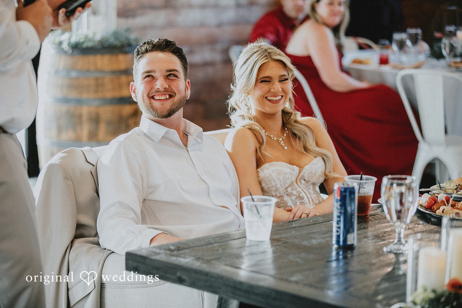 Catalyna + Nik Couple seated at the reception table during the wedding celebration