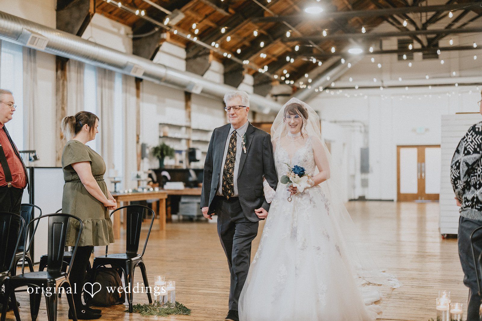 Stefani + Andrew Bride walking down the aisle at Ederer Hall