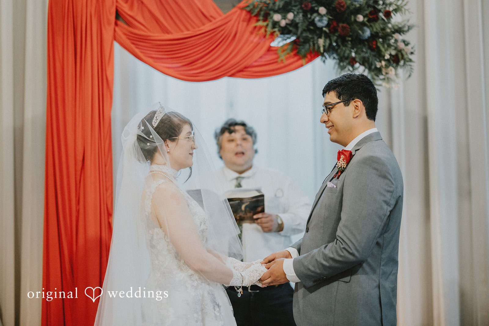 Stefani + Andrew Wedding couple holding hands during ceremony at Ederer Hall captured by Seattle wedding photographers from Original Weddings