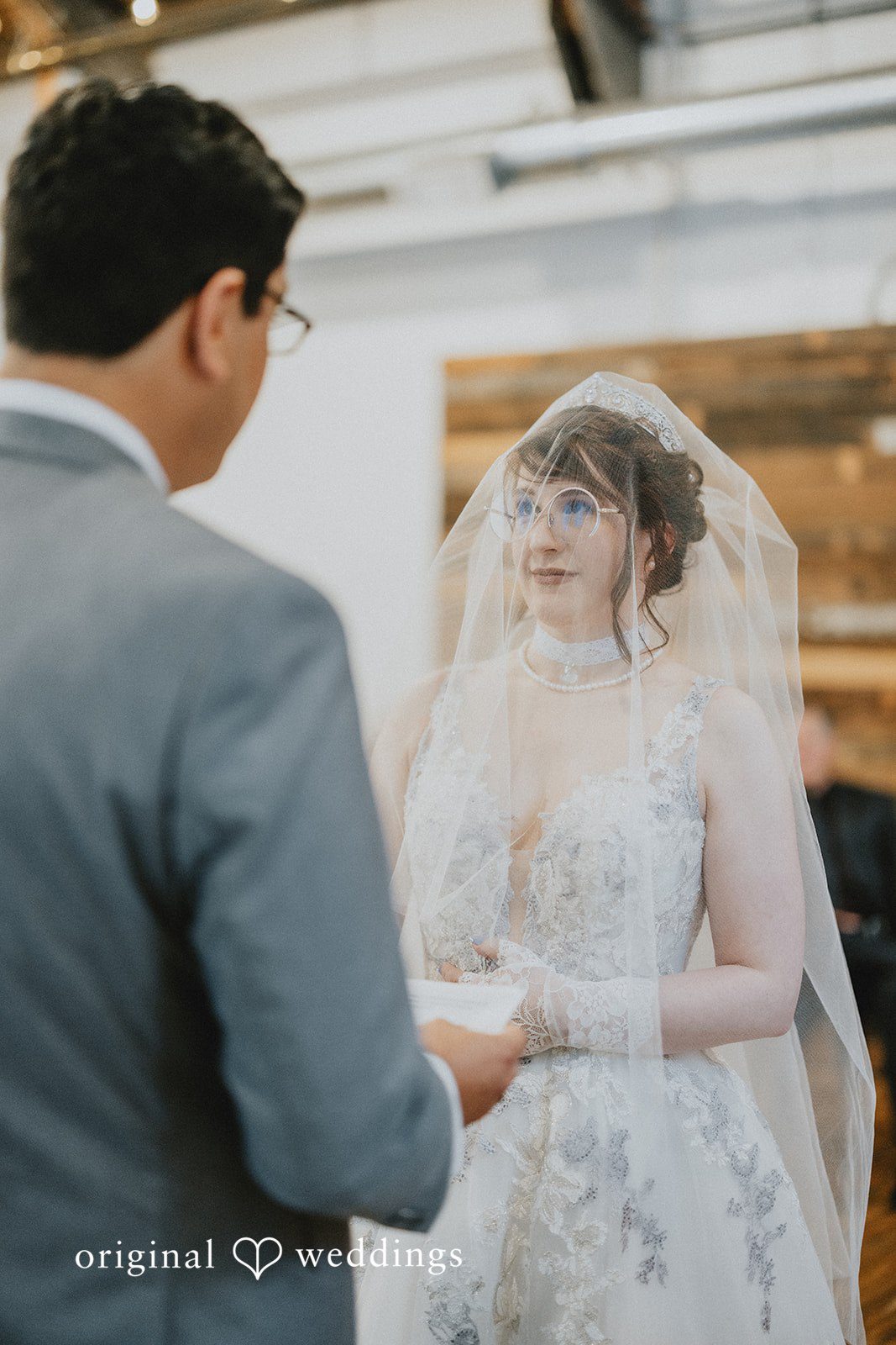 Stefani + Andrew Wedding couple holding hands during ceremony at Ederer Hall