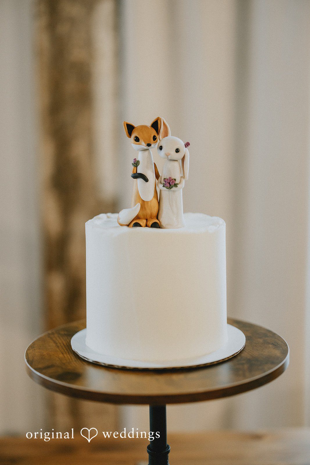 Stefani + Andrew Beautiful wedding cake with unique fox and bunny cake topper
