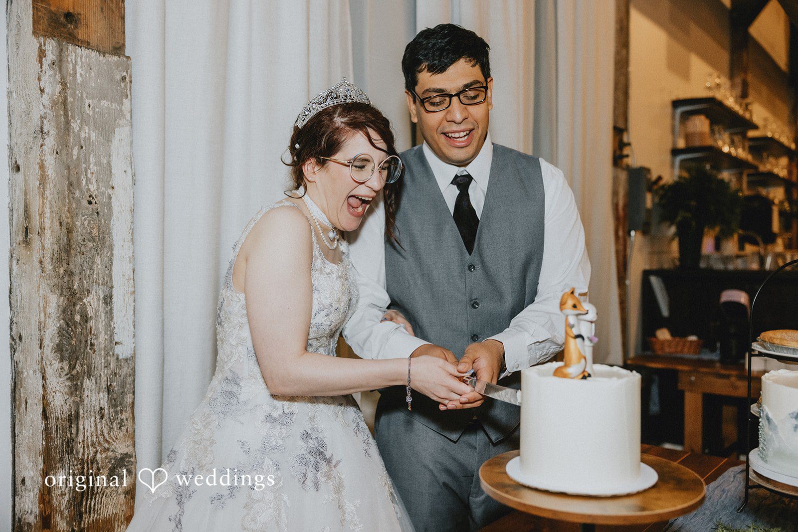 Stefani + Andrew Bride and groom cutting wedding cake during reception celebration