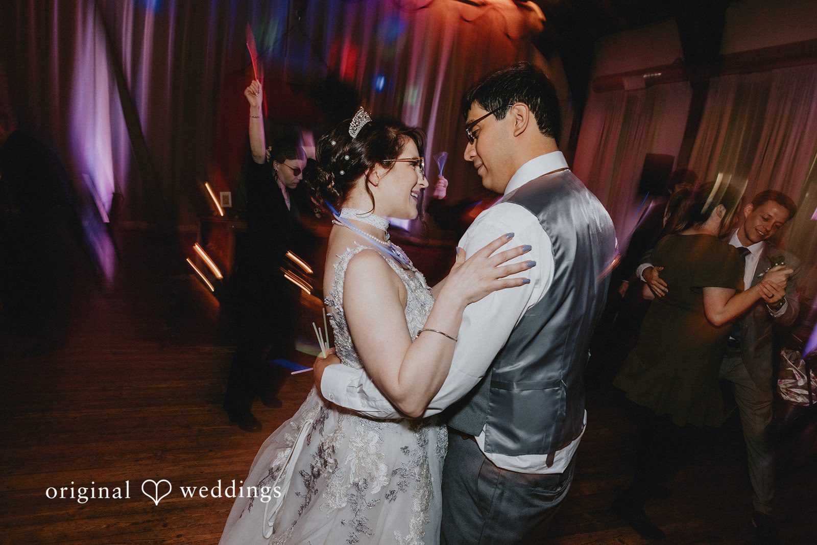 Stefani + Andrew Romantic newlywed dance floor moment with colorful reception lights